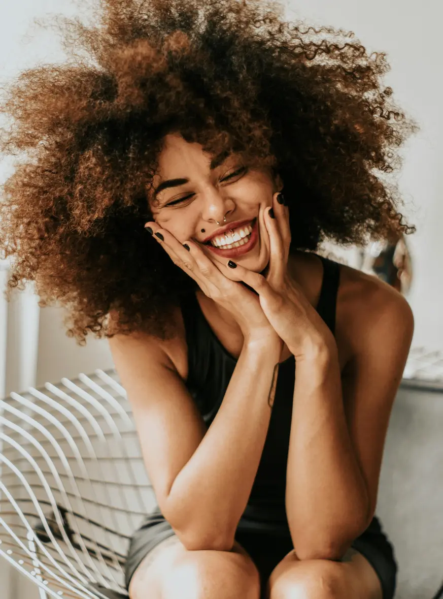 Woman with piercings sitting down and smiling